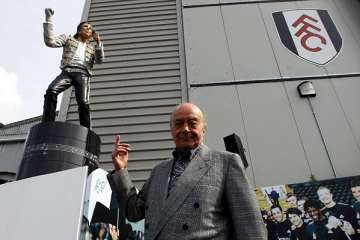 Mohamed al Fayed with Michael Jackson sculpture.